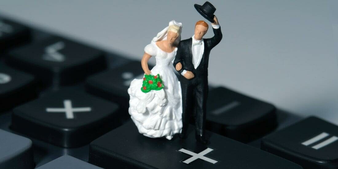 Model of a married couple on top of a calculator