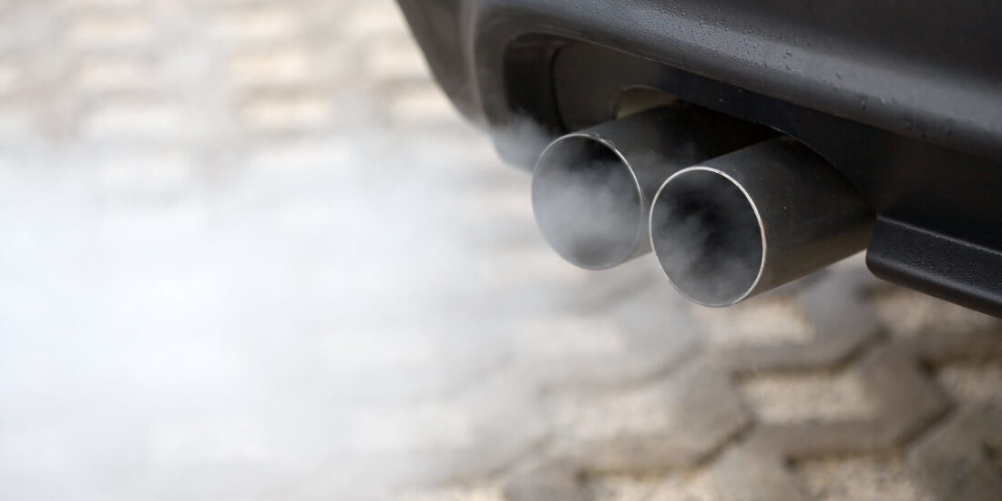 Close up of car exhaust with smoke coming out