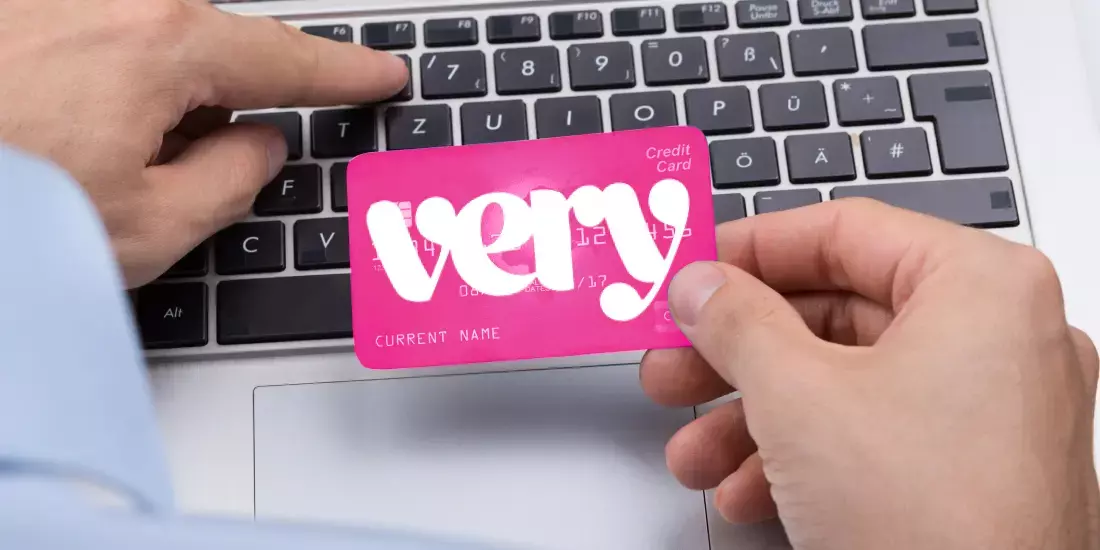 A Very credit card being typed out in front of a keyboard