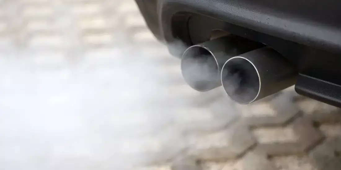 An exhaust of a car pumping out smog