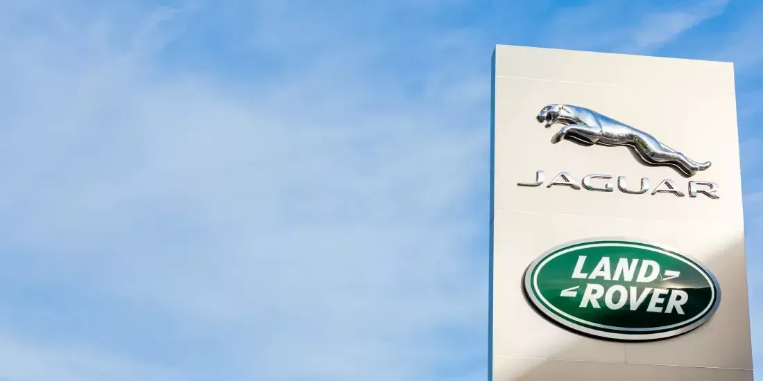 Jaguar and Land Rover logos against a blue sky backdrop