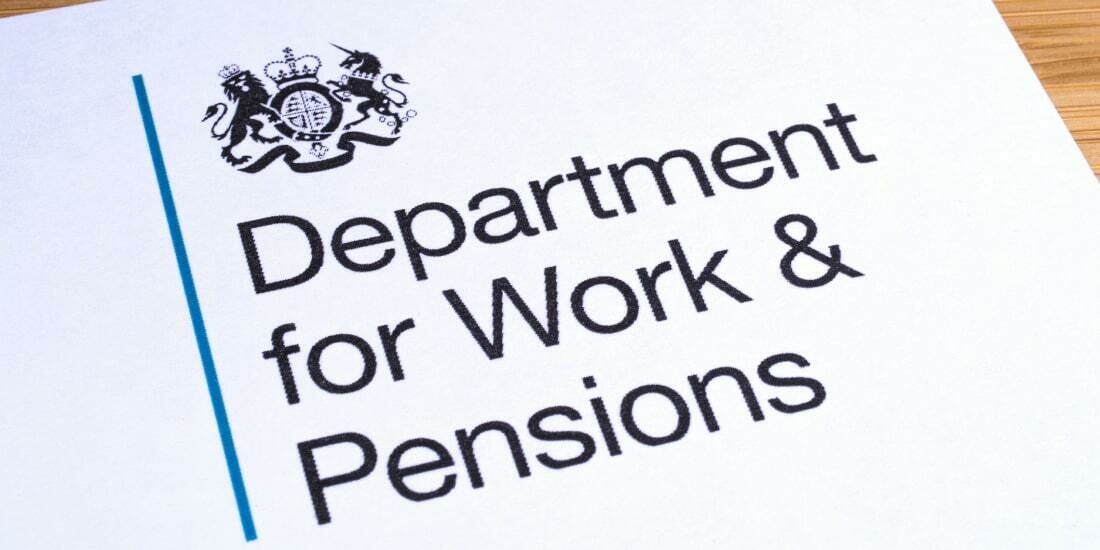 The DWP logo on a piece of paper on a desk